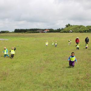 Løbende børn på græsmark